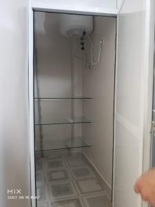 a glass refrigerator with a glass shelf in a room at New Luxury Apartment, 3 Bed, 7Mins to Beach - Aida in Tangier