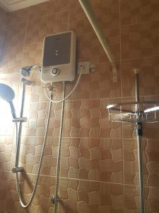 a shower in a bathroom with a shower at Temaya Cottage Lodge in Tamale