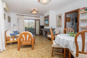 a living room with a table and chairs at OLIVAR de S’HERETAT Trekking/ruta GR-221 (ETV/2099) in Sóller