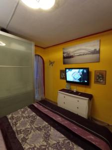a bedroom with a bed and a tv on a cabinet at boungalow Mena Playmar in San Bartolomé
