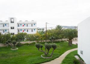 uma vista para um jardim com árvores e edifícios em Lilly Apartment em Faliraki