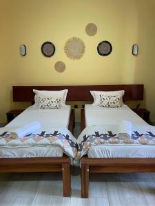 Postel nebo postele na pokoji v ubytování Havana Hôtel