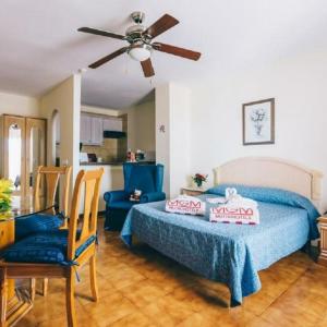 a bedroom with a bed and a ceiling fan at Sunshine Apartments in San Miguel de Abona