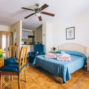 a bedroom with a bed and a ceiling fan at Sunshine Apartments in San Miguel de Abona +20 photos