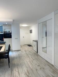 an empty living room with a table and a kitchen at Holiday 88 in Leukerbad +8 photos