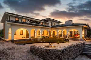 a large house with a fountain in front of it at Delta MAYANKA in Mineri