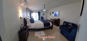 a bedroom with a bed and a couch in a room at casaenjoysamana in Los Naranjos