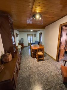 a living room with a table and a dining room at Can Xuneta in Bagá