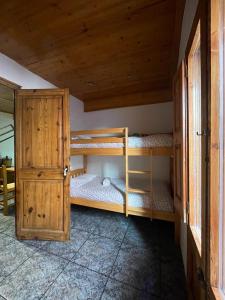 a room with two bunk beds and a wooden cabinet at Can Xuneta in Bagá