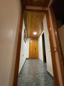 a hallway with a wooden door in a house at Can Xuneta in Bagá