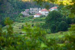 a group of houses on a hill with trees at Férias de Sonho in Arcos de Valdevez