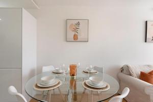 a living room with a glass table and a couch at Spacious Two Bed loft Apartment in Birchanger