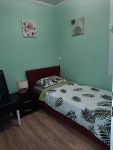 a bedroom with a bed with a black and white comforter at Apartman Dominik in Zagreb