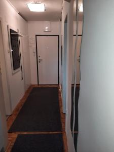 a hallway with a door and a black rug at Apartman Dominik in Zagreb