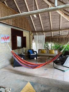 a hammock in a living room of a house at Casa los Almendros in Guamo