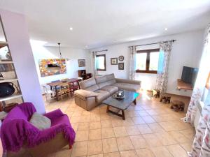 a living room with a couch and a table at es cau in Manacor