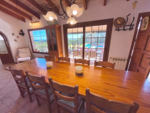 a dining room with a large wooden table and chairs at es cau in Manacor