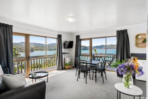 a living room with a view of the water at Tipi and Bobs Waterfront Lodge in Tryphena