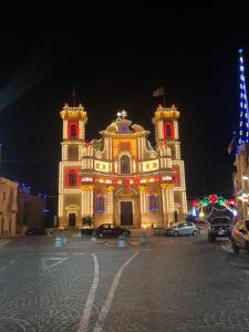 a large building with lights on it at night at Fiftyfour West Boutique Living in Għarb