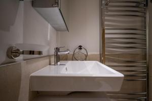 a white sink in a bathroom next to a shower at Magnolia House, Rye in Rye +37 photos