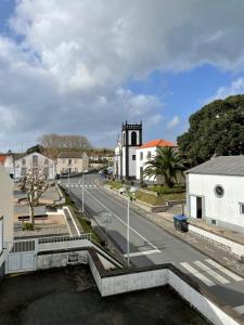 a town with a river and a church and a street at Arco´s Apartment 2 in Ponta Delgada +6 photos