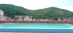a swimming pool with a mountain in the background at La Vicente in Salta