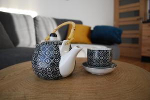 a coffee table with a tea pot and a cup at Apartmán U Suchého buku - Buková Hora in Červená Voda