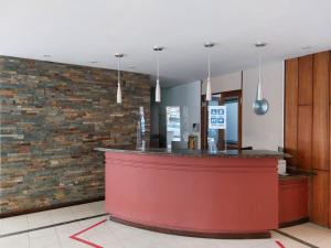 a bar in a restaurant with a brick wall at Punta del Este -Edificio Kennedy Apto 106 in Punta del Este