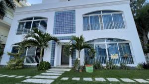 
a large white house with a large window at GAVA hostel in Punta Cana
