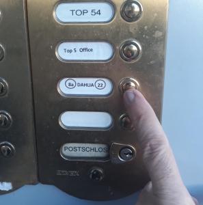 a hand is pressing a button on an electronic device at Apartment Dahlia Vienna in Vienna