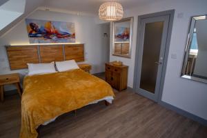 a bedroom with a bed with a orange blanket at Magnolia House, Rye in Rye