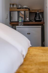 a bedroom with a bed and a counter with bottles on it at Magnolia House, Rye in Rye