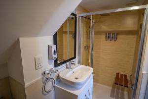 a bathroom with a sink and a shower at Magnolia House, Rye in Rye