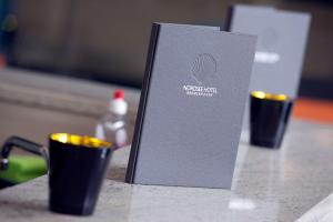 a book sitting on top of a counter with cups at Nordsee Hotel City in Bremerhaven +15 photos