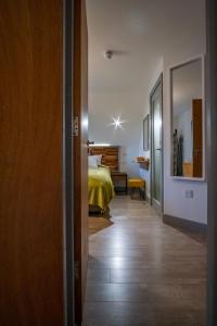 a room with a bed and a room with a hallway at Magnolia House, Rye in Rye