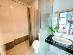 a bathroom with a toilet and a sink and a shower at PJ Patong Resortel in Patong Beach