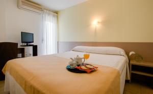 a hotel room with a bed with a tray of food and drinks at Hotel Felix in Lorca +40 photos