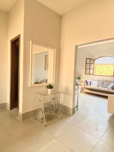 a living room with a table and a bed at Casa 105 in Arraial do Cabo +9 photos