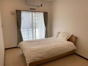 Cama ou camas em um quarto em ホテルトーマス前島