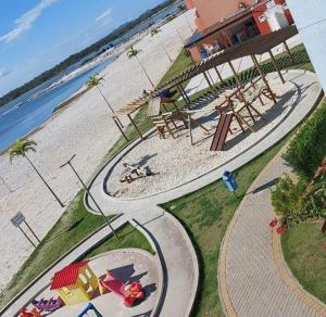 an aerial view of a playground next to the beach at Resort GoldenLake em Arraial do Cabo in Arraial do Cabo