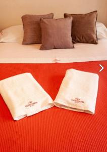 a bed that has two pillows on it at Apart Hotel Cordoba Inn in Córdoba
