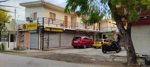 a red car parked in front of a building at BM Island Inn in Bantayan Island