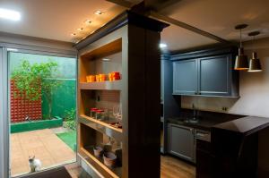 a kitchen with blue cabinets and a cat sitting on the floor at Apto climatizado na Praia de Iracema, 3 min da praia in Fortaleza