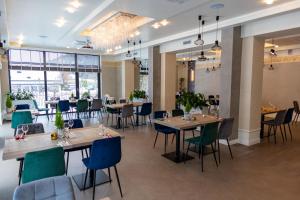 a dining room with wooden tables and chairs at Hotel Alpin in Szczyrk