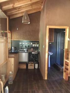 a kitchen with a sink and a stove at Puma Cottage in Horcon