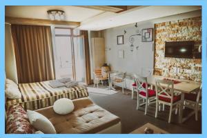 a living room with a couch and a table at MILMARI CENTRAL Private apartments in Kopaonik