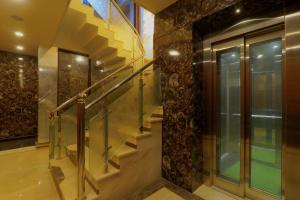 a staircase in a house with a glass railing at Shri Tirupati Residency in Nilmatha