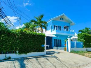 a blue house with a fence in front of it at 350m to beach pool villa in Hua Hin