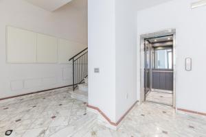 an empty room with a staircase and a door at Elena House Apartments in Viareggio