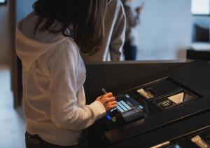 a woman standing in front of a cash register at fav Hida Takayama in Takayama
